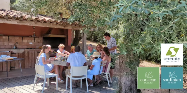 A family enjoying a meal together on holiday with Serenity Holidays.