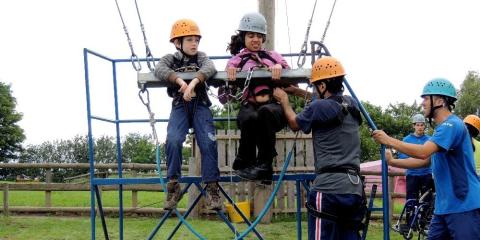 Riana and friend Ethan on the giant swing at PGL Boreatton Park.