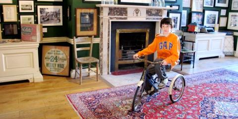 Riding the tricycle in the Little Museum.[copyright]Dea Birkett[/copyright]