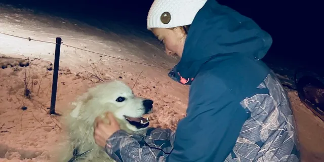 Olivia with a samoyed at the tipi camp